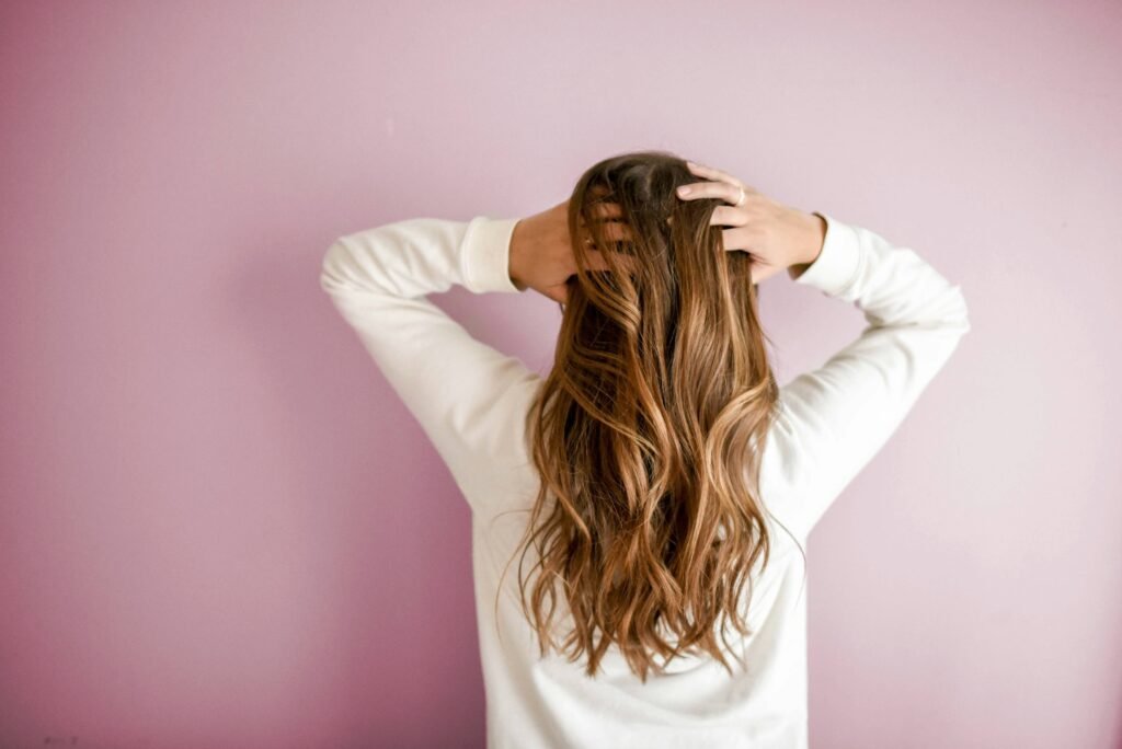 woman in white long-sleeved shirt standing in front of pink wall. Image Credit: Element5Digital | Unsplash