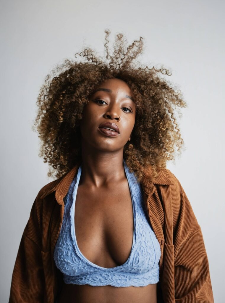 woman with brown hair in a brown jacket. Image Credit: Tobe Mokolo | Unsplash