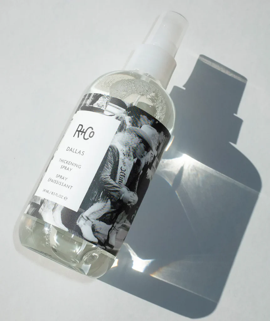 "Bottle of R+Co Dallas Thickening Spray – lightweight volumizing mist for fine, straight hair enriched with Biotin and Vitamin B5